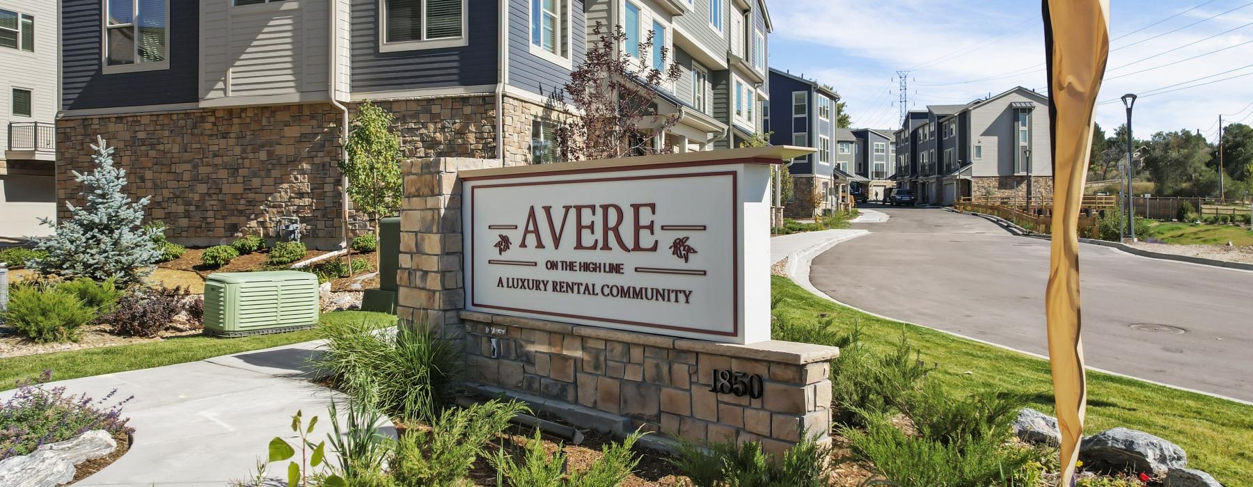 a sign in front of a row of apartments