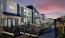 a row of apartments with fenced-in lawns