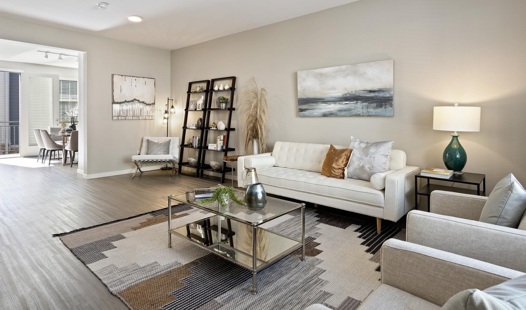 Generous bedroom offerings to fit every family a living room with a large rug and a coffee table