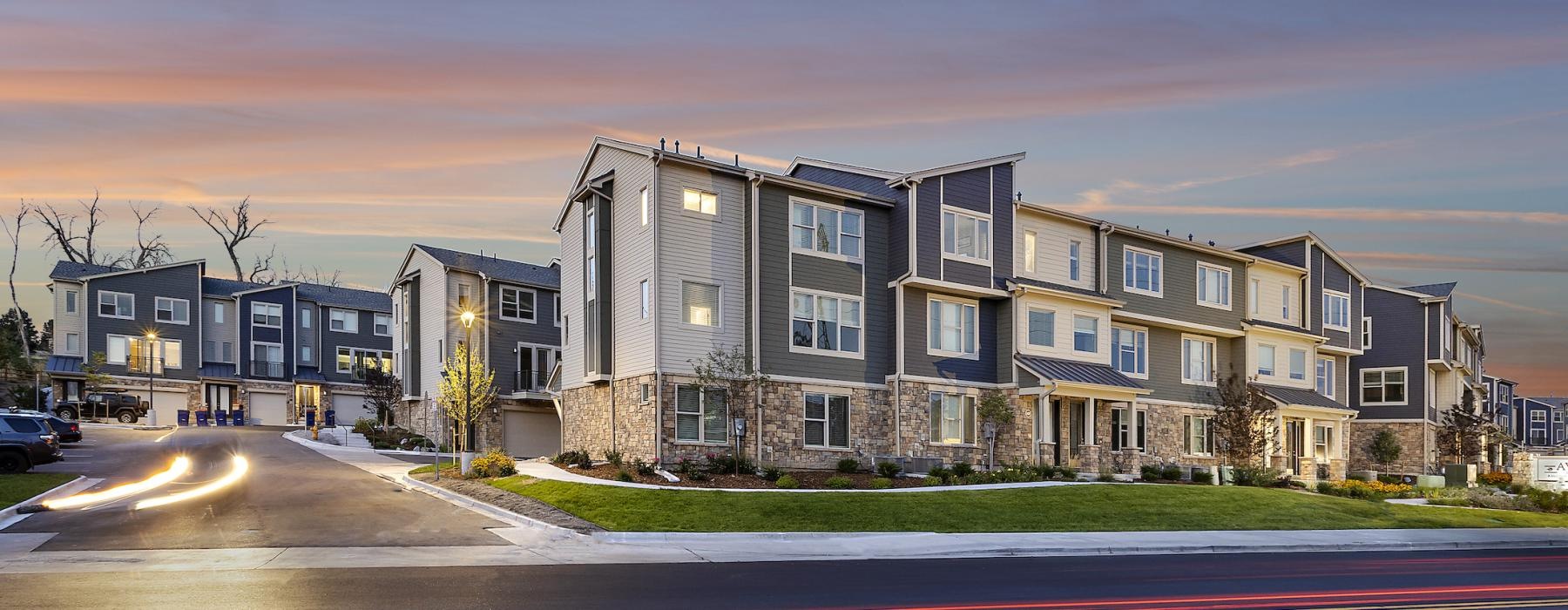 an apartment property with cars driving by