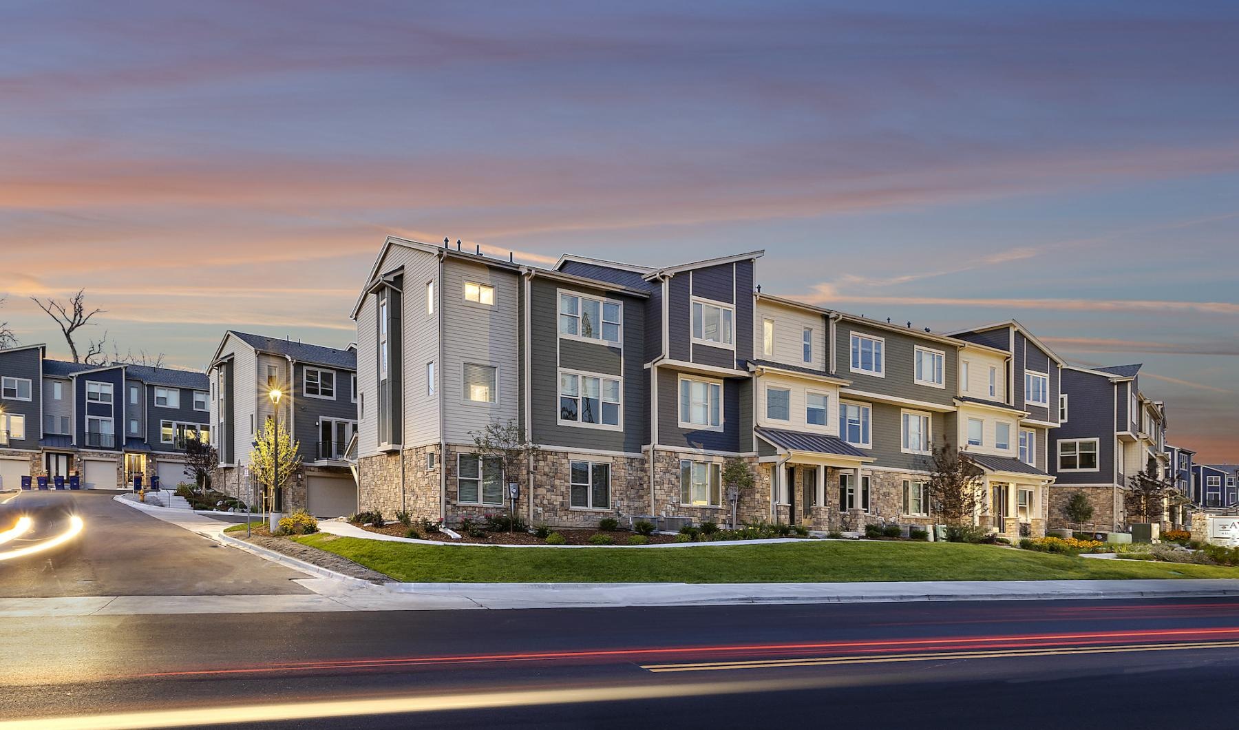 an apartment property with cars driving by